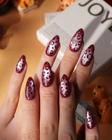 Claret leopard cat eye press on nails, deep wine red base with a rose gold shimmer band and hand-painted black leopard spots - image 1