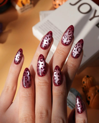Claret leopard cat eye press on nails, deep wine red base with a rose gold shimmer band and hand-painted black leopard spots - image 1