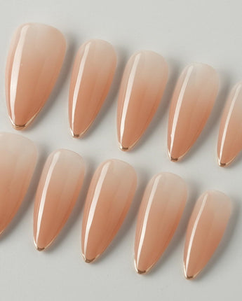 Clean Grace press-on nails in medium stiletto shape — gold french tip nails