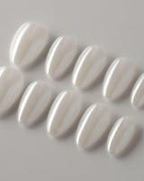 Clean Pearl press-on nails in extra short almond shape — white chrome nails