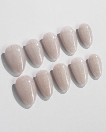 Clean Rainbow Cat-eye press-on nails in extra short almond shape — pale pink cat eye nails