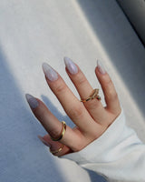 Clean Rainbow Cat-eye nail art close-up showing pale pink cat eye nails details