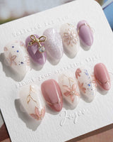 Clematis-Visionaria press-on nails in extra short almond shape — Elegant Taro Purple, Hand-painted Clematis & Delicate Bow.