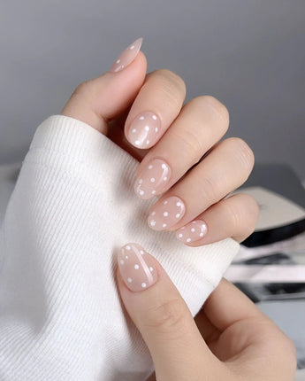 Cloud Cream-Mini nail art close-up showing Peach Nude, Sweet White Polka Dots. details
