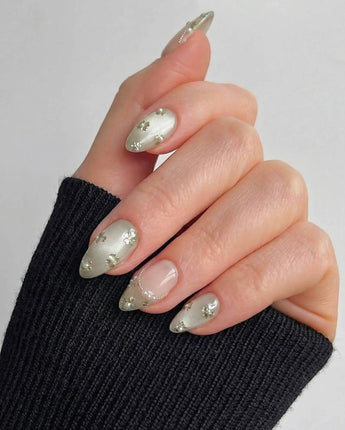 Clover Field press-on nails in short almond shape — Fresh Grass Green, Hand-painted Metallic Florals & French Pearl Outlines.