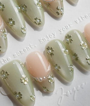 Clover Field press-on nails in short almond shape — Fresh Grass Green, Hand-painted Metallic Florals & French Pearl Outlines.