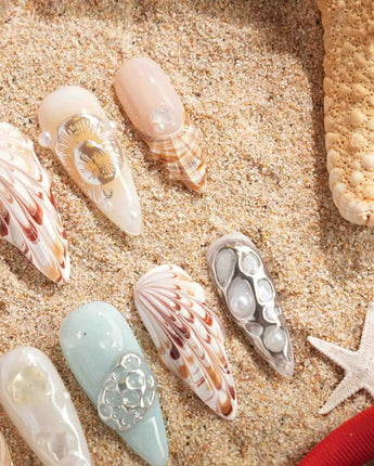 Coastline Edit summer nail set with starfish, shell charms, and salty-air shimmer