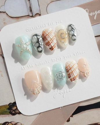 Coastline Edit close-up of glossy ocean nails with shells, pearls, and starfish