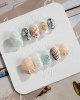 Coastline Edit beach-luxe nails with 3D shell texture and pearl highlights