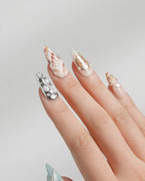 Coastline Edit medium stiletto nails with azure nude ocean style and 3D shells