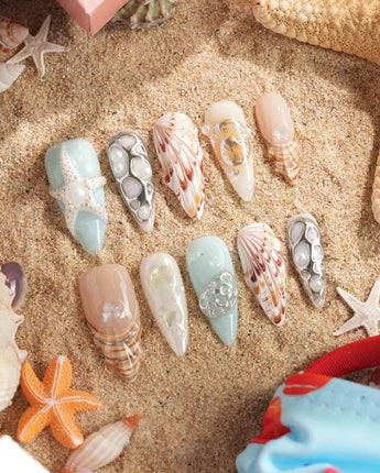 Coastline Edit spiral reef nail art with metallic seashell and pearl details