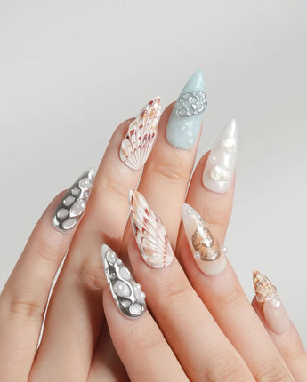 Coastline Edit moody seashell nails with silver, brown, and gold tide accents
