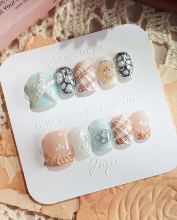 Coastline Edit stiletto press-on nails with seashells, starfish, and pearls