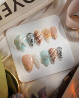 Coastline Edit ocean nails with brown-gold tide accents and sculpted shells
