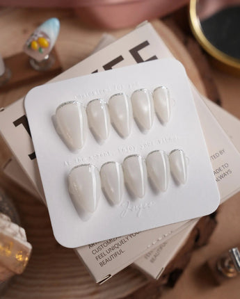 Coco Water press-on nails in short stiletto shape — Milky Jelly White, Minimalist Silver cat eye French Tips.