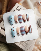 Cocoa Dot medium almond press-on nails with chocolate stripe and marble pattern mix