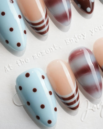 Cocoa Dot short almond nails with polka dots, stripes and deep wine marble swirls