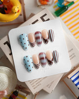 Cocoa Dot warm nude nails with chocolate stripes and hand-painted dots