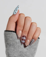 Cocoa Dot glossy blue and brown press-on nails with playful mixed patterns