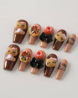 Cocoa Kitty Brown Color in medium coffin shape with brown 3D dessert nail accents