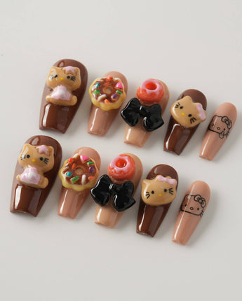 Cocoa Kitty Brown Color in medium coffin shape with brown 3D dessert nail accents