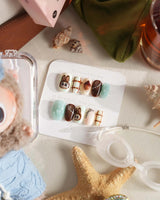CocoaBoo Labubu nails with big-eye character face, brown chrome, mint jelly, and 3D paw detail