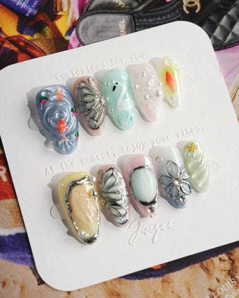 Como Blue soft luxury nails with butterfly sculpture, goldfish, and pearl dew accents