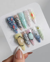 Como Blue long stiletto nails with pearly pastels, 3D butterfly wings, and goldfish
