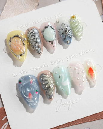 Como Blue short stiletto nails with pearly ripples, butterfly wings, and goldfish