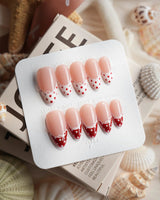 Coquette Dot glossy coquette nails with red French tips and white polka dots