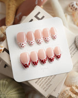 Coquette Dot extra short almond press-on nails with red dots and white lace trim