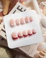 Coquette Dot extra short squoval press-on nails with coquette bow and lace details