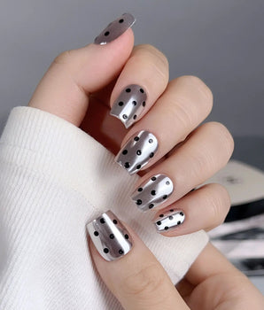 Cosmo Dots nail set with reflective silver chrome and playful black dotted accents