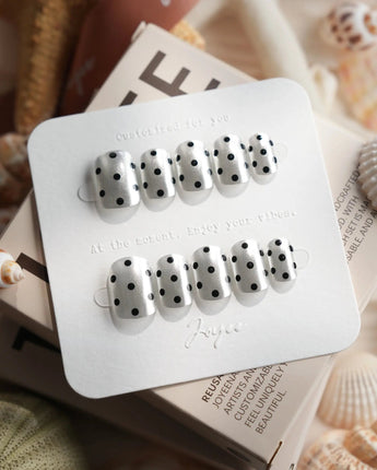 Cosmo Dots in extra short squoval shape with silver chrome and black polka-dot nail art