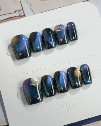 Cosmoseek cosmic nail art with Saturn rings, star sparkle, and glossy gel finish