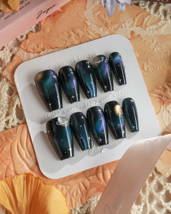 Cosmoseek night-sky nails with blue chrome shimmer and raised planet accents
