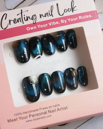 Cosmoseek handmade space nails with chrome cat-eye glow and tiny stars