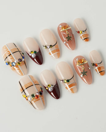 Cozy Plaid press-on nails in medium almond shape — British Plaid, Colorful Rhinestone & Planet Charm.