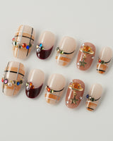 Cozy Plaid press-on nails in short oval shape — British Plaid, Colorful Rhinestone & Planet Charm.