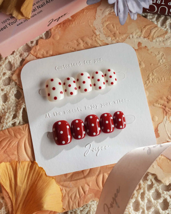 Creamy Cherry press-on nails with bright red and creamy white retro polka dot design