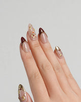 Gothic Red press-on nails with ornate gold and silver cross details on burgundy red nails