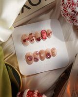 Crystal Berry press-on nails with red cat-eye gel, gold lines and glossy cherry-inspired nail art