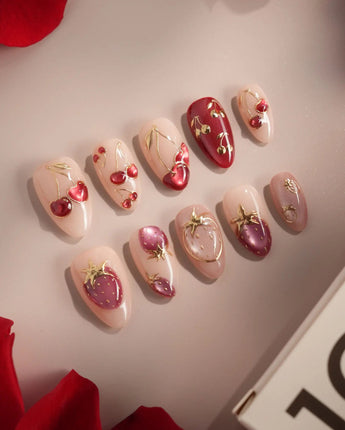 Crystal Berry press-on nails with nude base, berry red shimmer and glossy cherry accents