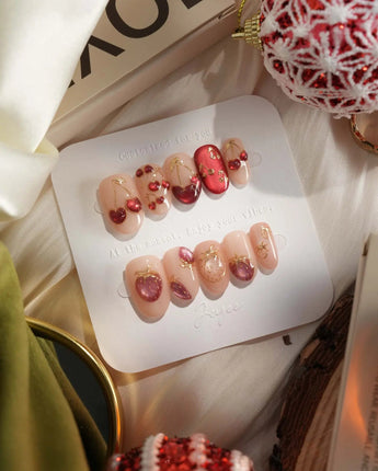 Crystal Berry press-on nails with deep red cat-eye shine, cherry accents and dimensional gel finish