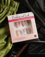 Wonderland Whims handmade floral nails with pink blossoms, pearls, and glossy gel finish