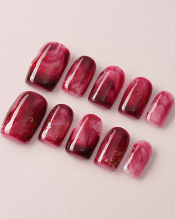 Gone with the Wind press-on nails with marbled burgundy and gold foil accents