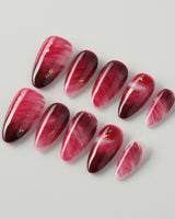 Gone with the Wind press-on nails with marbled burgundy and gold foil accents