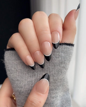Close-up of Classic Return - Ebony with black French tips and fine white line detail