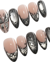 Damask press on nails with freehand black filigree scrollwork and a butterfly on nude and silver cat eye - image 1