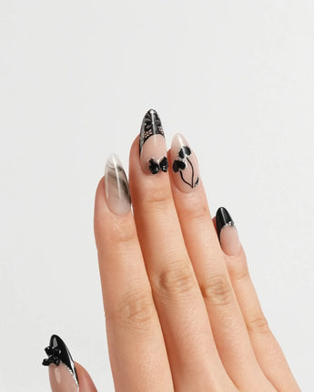 Dark Cherry press-on nails in medium almond shape — Chic Black & Nude, Lace Bows, Ink Marble Swirls & Glitter Heart Cherries.